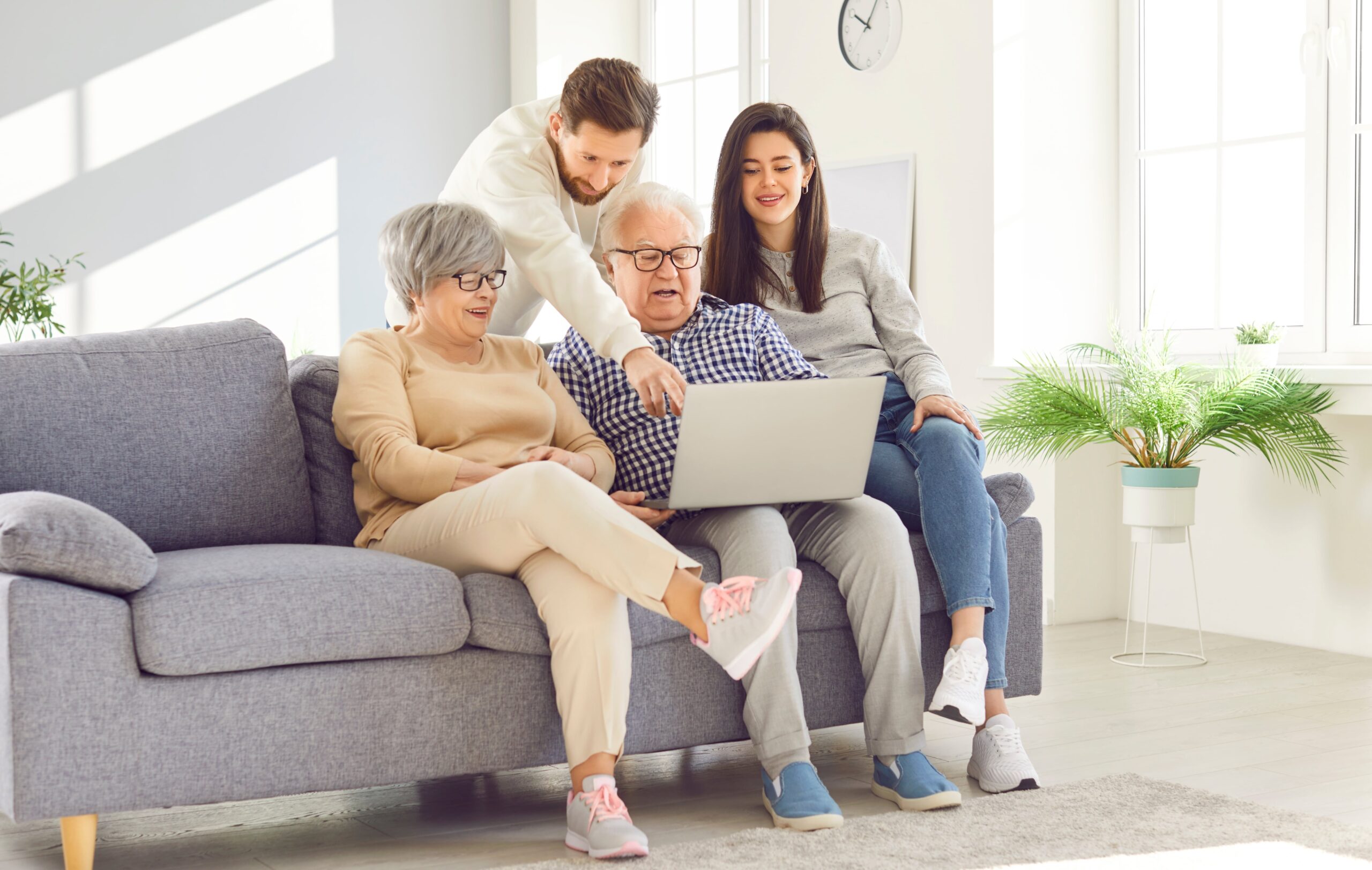 Young couple on sofa help parents in planning for long term care