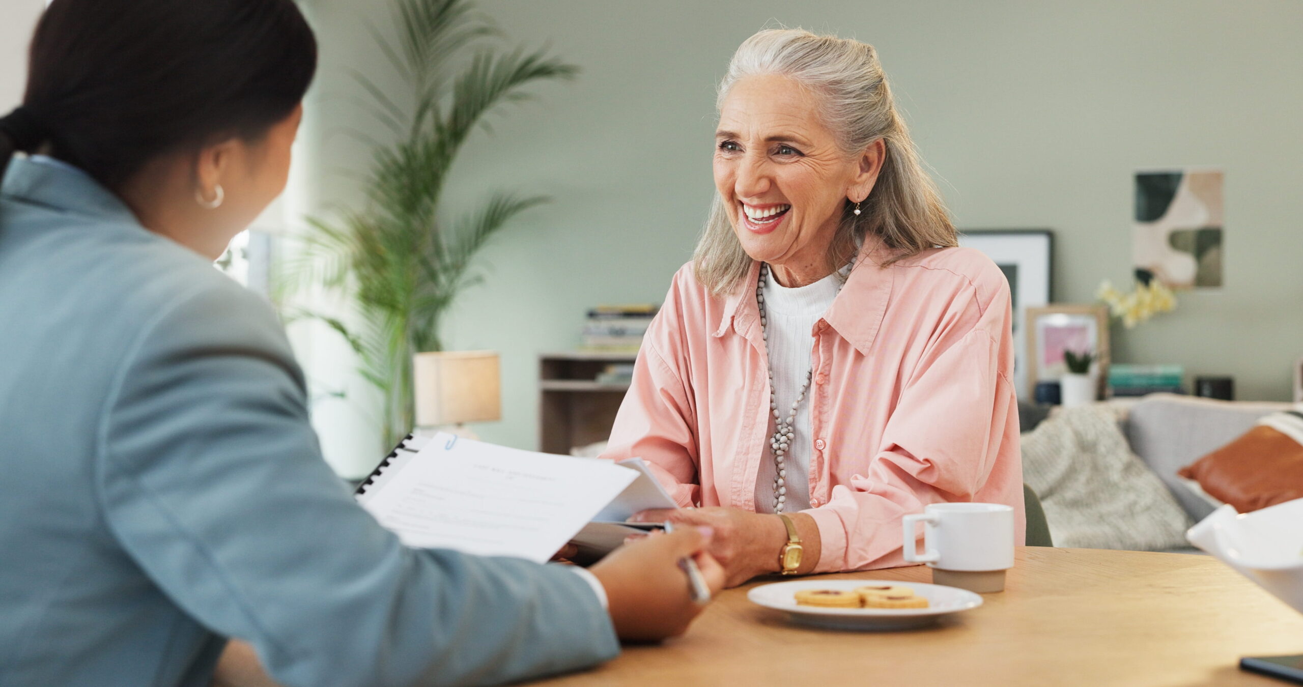 Will writers in Essex discussing a Will review with a client at home.
